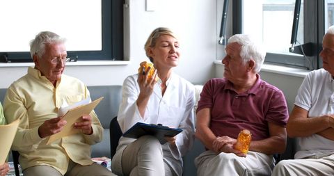 Doctor Consulting Older Adults on Medication