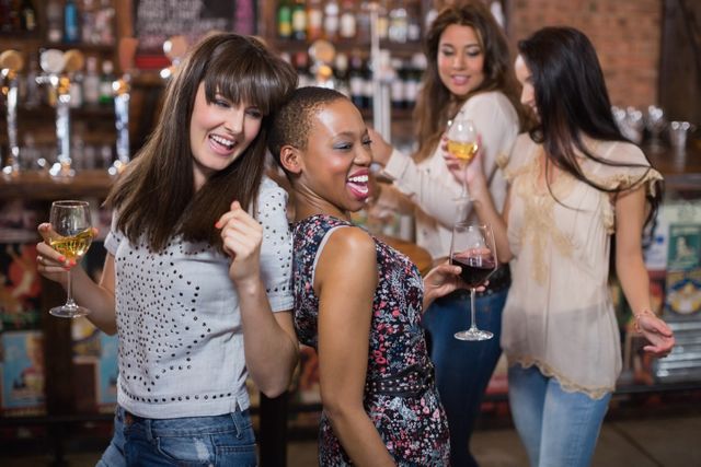 Happy female friends enjoying at pub