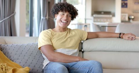 Smiling Man Relaxing on Couch in Modern Living Room - Download Free Stock Images Pikwizard.com