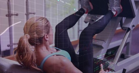 Woman pressing leg press machine wearing teal sports bra with fitness data overlay