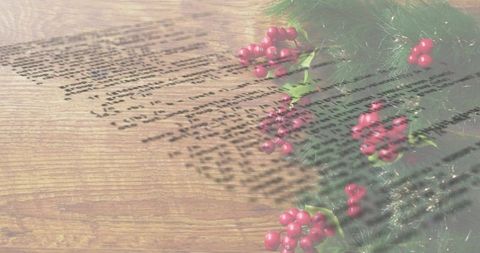 Displaying vintage holiday greenery with holly berries and script projection on rustic wood