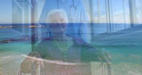 Senior Woman in Wheelchair and Medical Professional Over Seascape
