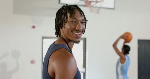 Cheerful Athlete Smiling During Basketball Training in Gym
