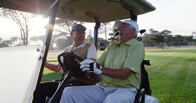 Two golfers laughing together in their golf buggy at golf course