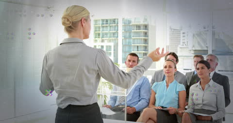 Business Professional Presenting to Diverse Team in Modern Office