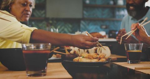 Friends sharing appetizers at a restaurant in slow motion