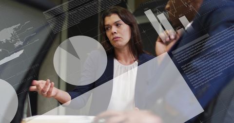 Businesswoman analyzing data with infographic interface in office