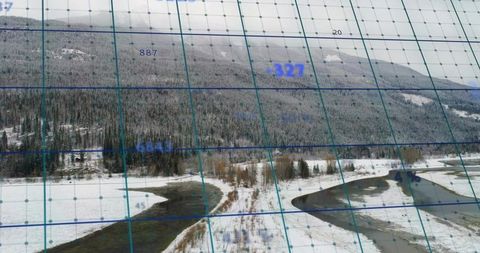 Survey aircraft mapping snowy river split over boreal forest with live grid overlay