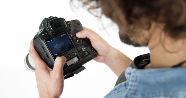 Photographer Adjusting DSLR Camera Settings in Studio - Download Free Stock Images Pikwizard.com