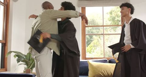 Joyful graduate celebrations at home with hugs