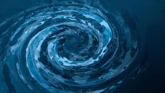 Whirlpool Forming Intricate Concentric Ripples in Deep Blue Water