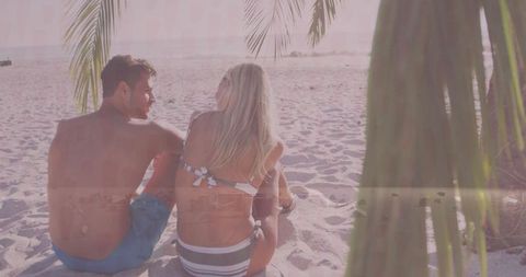 Couple Relaxing on a Serene Tropical Beach at Sunset