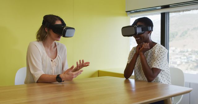 Two Women Experiencing Virtual Reality Headsets in Bright Office - Download Free Stock Images Pikwizard.com