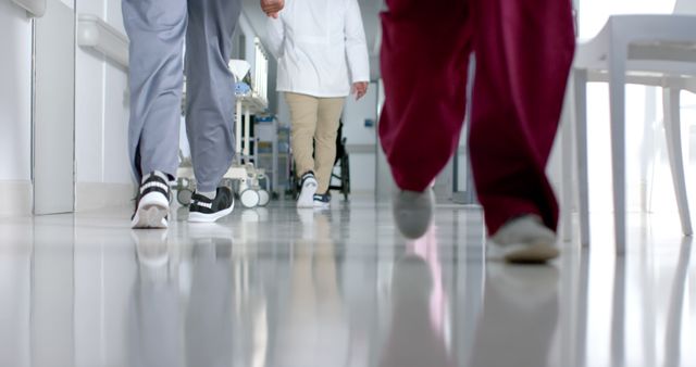 Health Professionals Walking Hospital Hallway with Reflection - Download Free Stock Images Pikwizard.com