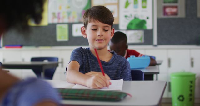 Happy Student Writing in Notebook During Classroom Activity - Download Free Stock Images Pikwizard.com