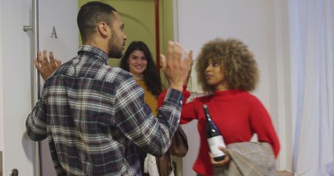 Young Adults Gathering for Festive House Party Arrival