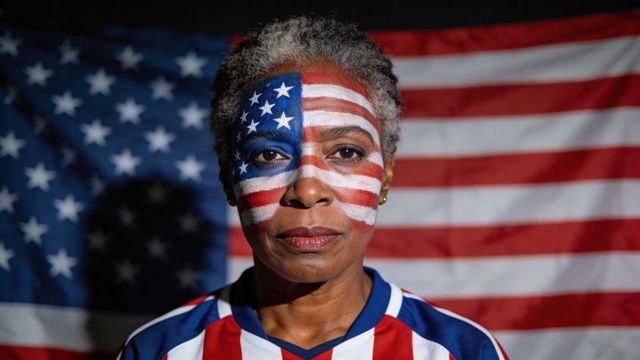 Mature woman wearing sports jersey with american flag face paint closeup