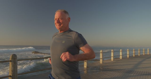 Senior Man Jogging Along Oceanfront Pier During Sunrise for Exercise - Download Free Stock Images Pikwizard.com