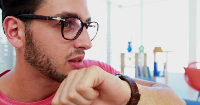 Man with Glasses Checking Time on Watch in Modern Office - Download Free Stock Images Pikwizard.com