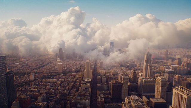 Dynamic urban skyline with towering cumulus clouds