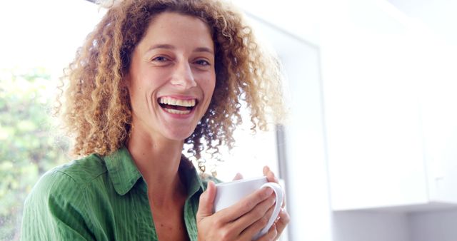 Smiling Woman Enjoying Coffee in Bright Kitchen - Download Free Stock Images Pikwizard.com