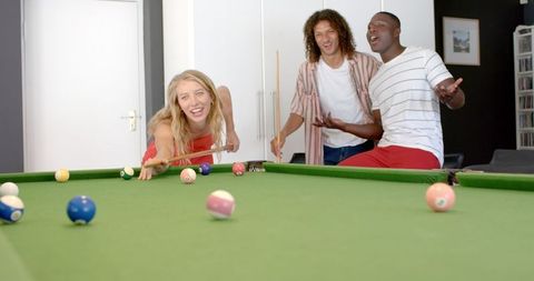 Friends Enjoy Casual Game Night with Pool Table Challenge