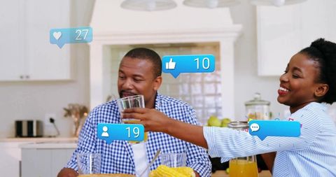 Couple Toasting with Juice and Social Media Notifications