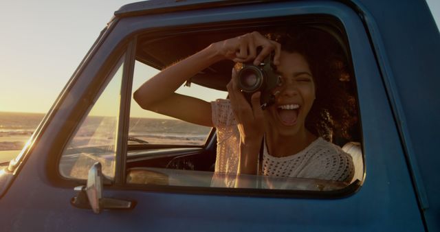 Happy Woman Photographing Sunset from Car Window at Beach - Download Free Stock Images Pikwizard.com