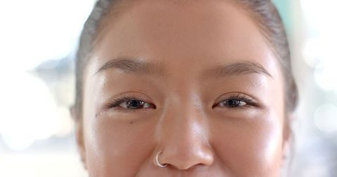 Close-up of Smiling Teenager with Nose Ring