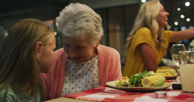 Grandmother Spending Quality Time with Young Girl at Dinner Table - Download Free Stock Images Pikwizard.com