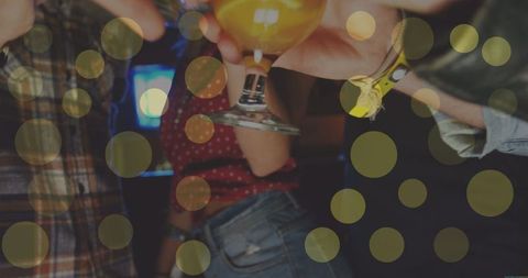 Friends Celebrating with Drinks and Festive Lights