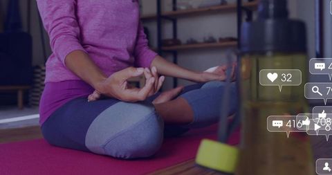 Woman Meditating at Home Amidst Social Media Notifications