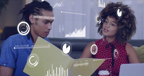 Colleagues analyzing data with digital charts for modern business project