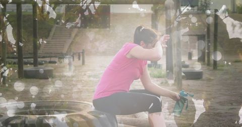 Woman resting during outdoor fitness training