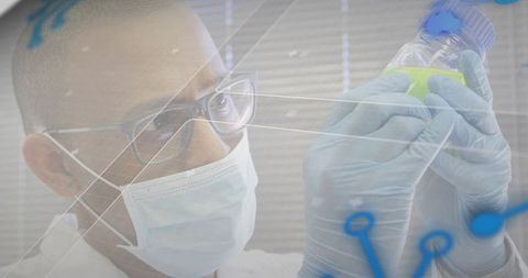 Scientist holding vial of yellow liquid inspecting sample with data overlay in laboratory