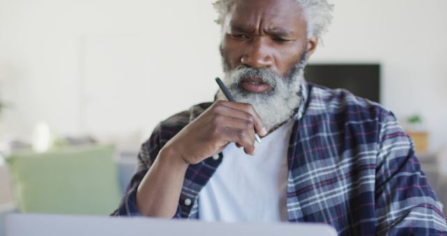 Senior Man Thinking While Using Laptop at Home Office - Download Free Stock Images Pikwizard.com