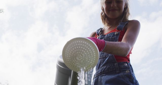 Girl Watering Plants with Watering Can in Garden on Sunny Day - Download Free Stock Images Pikwizard.com