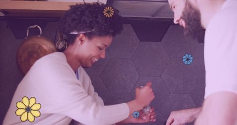 Happy couple cooking together with floral accents