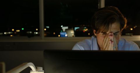Exhausted male executive working late at office computer