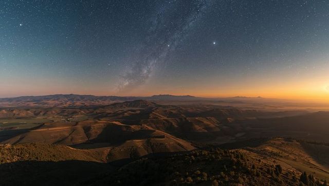 Milky Way Over Sunlit Mountain Valley at Dusk, Panoramic Starry Desert Landscape