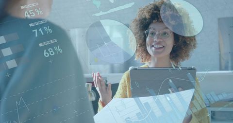 African American Businesswoman Discussing Digital Finance Data in Modern Office