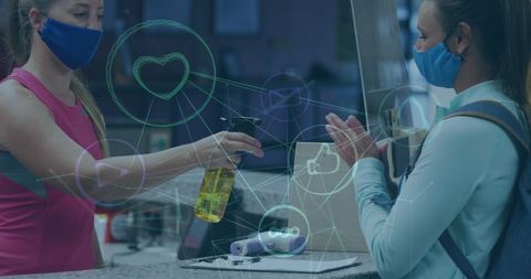 Worker disinfecting hands amid digital communication icons