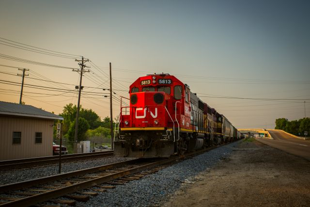 Red Locomotive Moving on Train Tracks During Sunset - Download Free Stock Photos Pikwizard.com