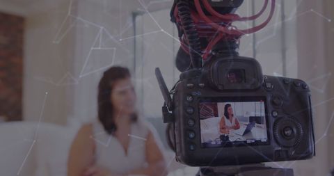 Female vlogger recording online video in home studio