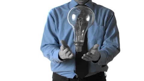 Man Handling Large Light Bulb with Innovation Concept