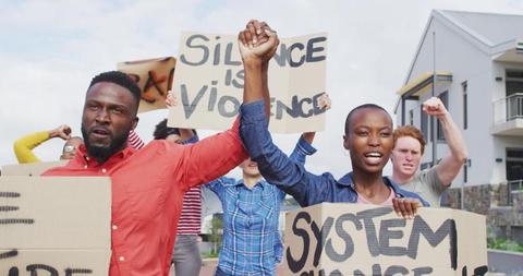 Diverse group of protesters holding cardboard banners and screaming. supporting human rights and fighting against racism.