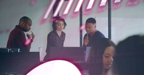 Multicultural Team Analyzing Data in Modern Office