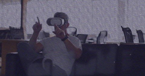Caucasian Man Experiencing Virtual Reality in Office VHS Style
