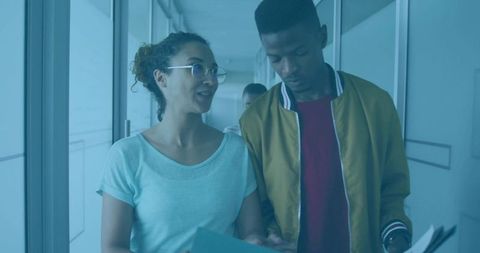 Colleagues Discussing in Modern Office Hallway