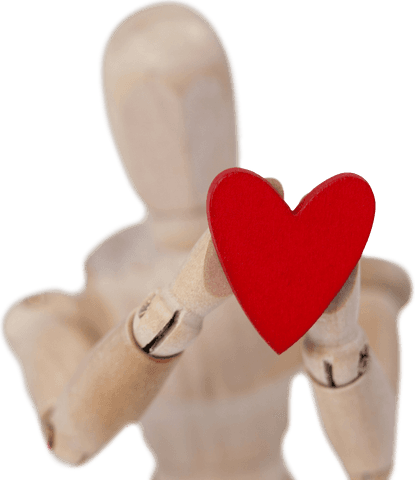 Transparent wooden mannequin holding red heart